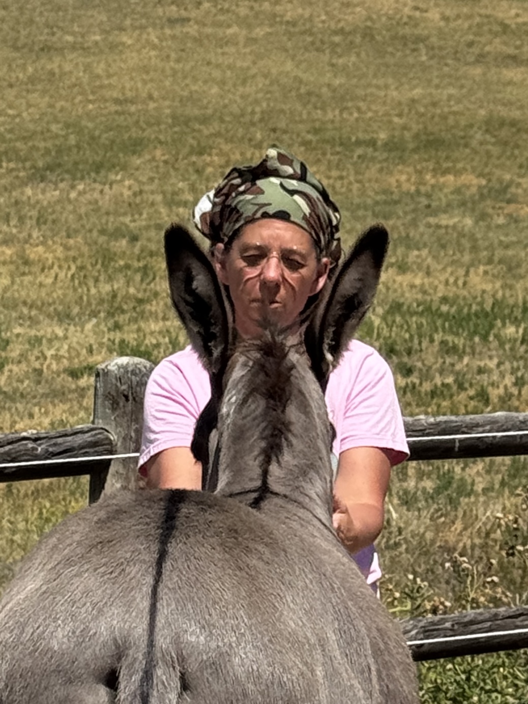 A burro's long ears framing Aunt Stacy's face from behind